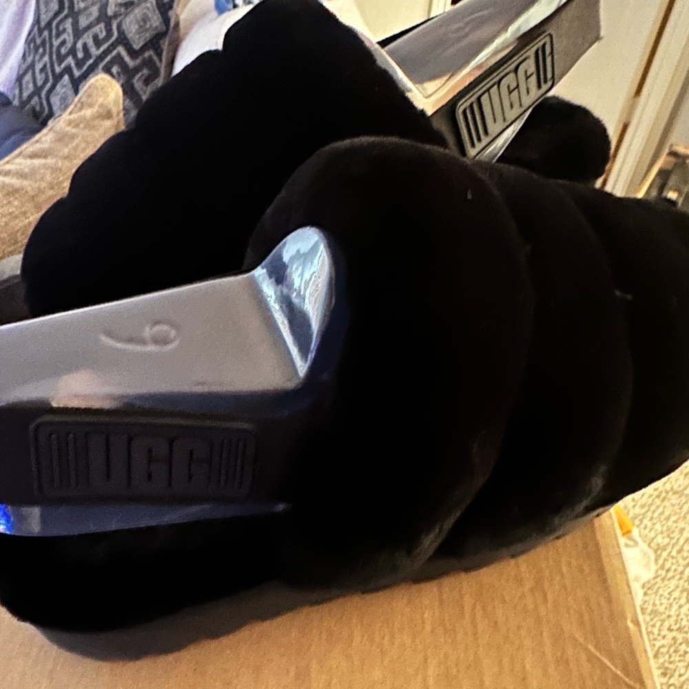 UGGS BLACK SLIPPER SANDLE WITH A STRAP .COMES WITH THE ORIGINAL BOX AS WELL.